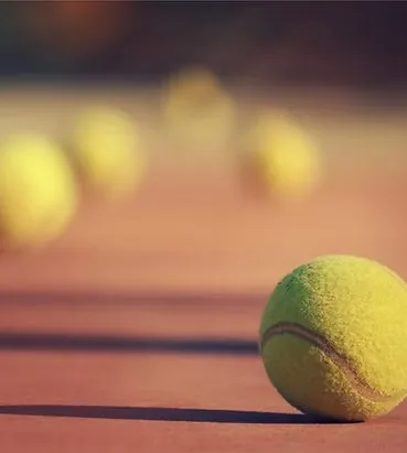 Tennis balls on a clay court