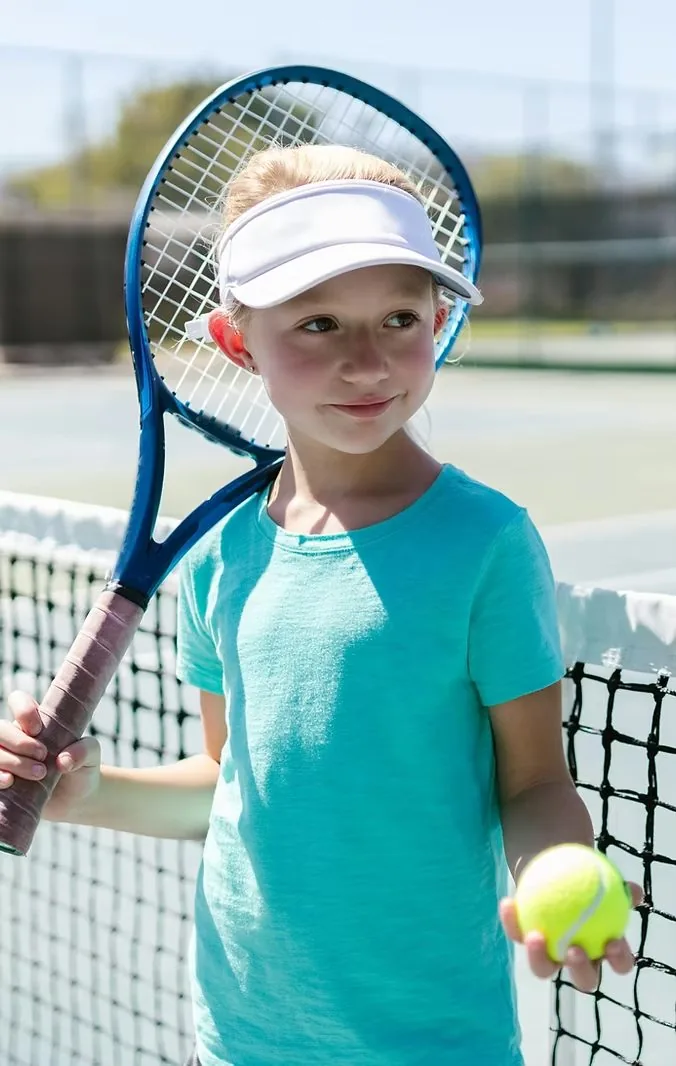 A young tennis player holding a racquet and ball at the net